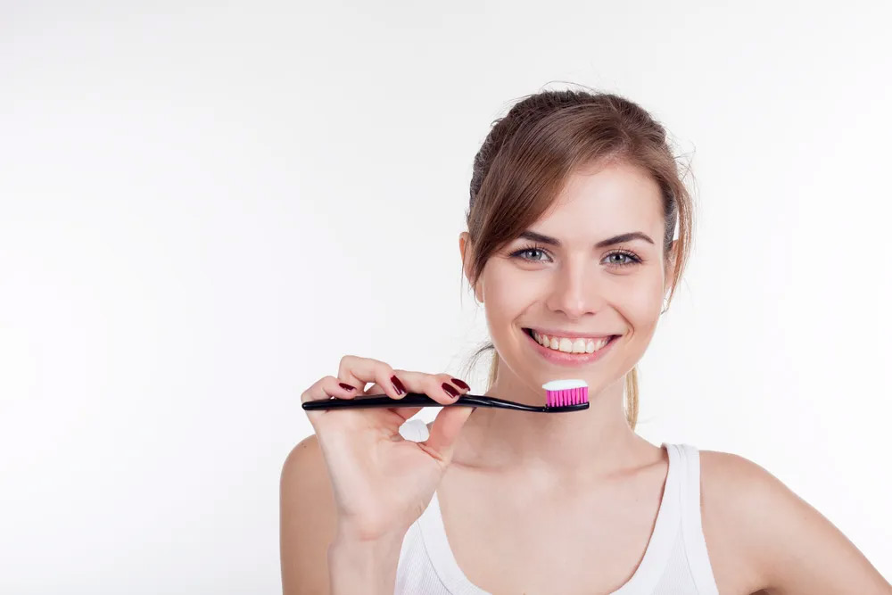 women using toothbrush