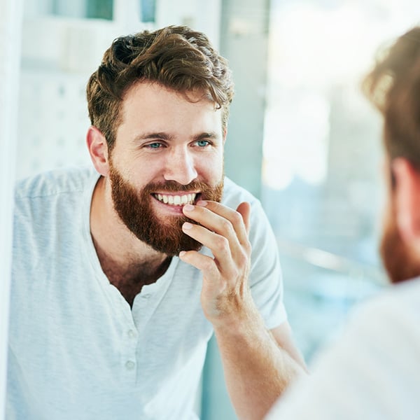 man smiling in mirror