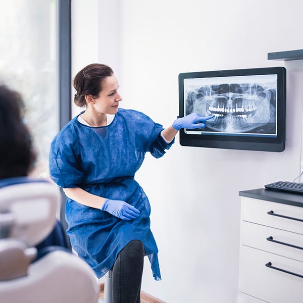 dentist showing patient xrays of teeth