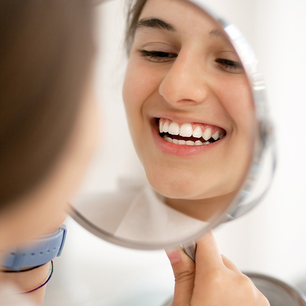 lady smiling in a mirror