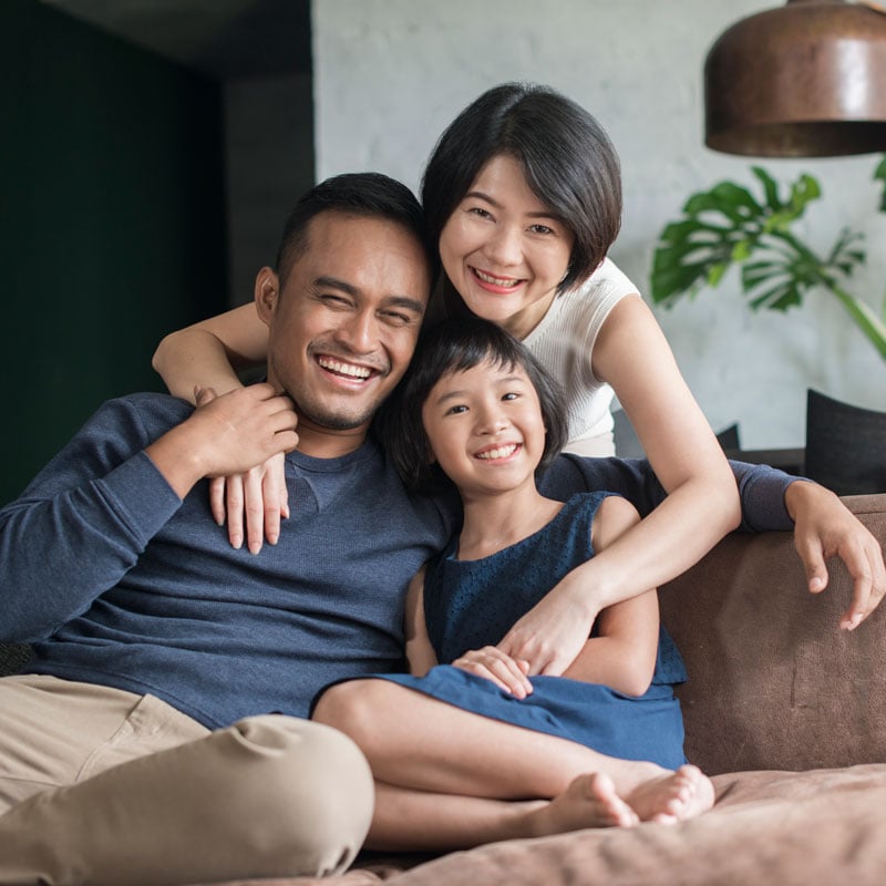 family on couch smiling