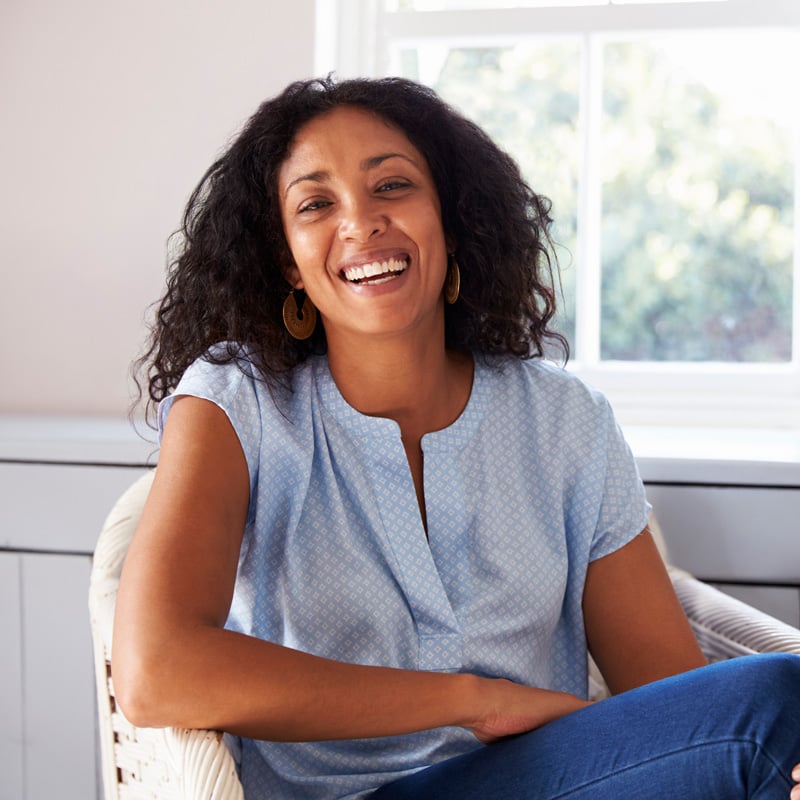 lady sitting in a chair smiling
