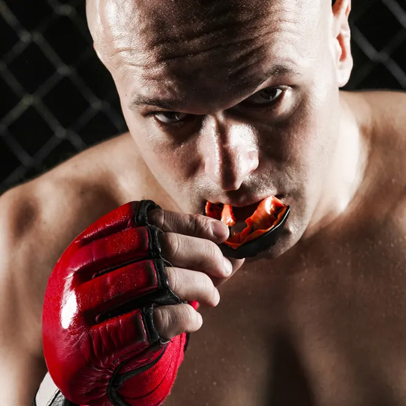 man with boxing gloves and mouth guard
